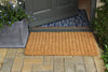 Atlantic Mats Coir Chedworth striped doormat in front of a grey door