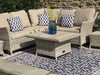 Atlantic Mats Recycled Rug in Antiqued Caption under a wicker outdoor sofa set