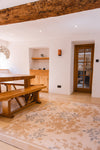 Atlantic Mats Gold Rose recycled rug in a rustic dining room with wooden furniture