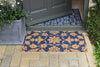 Atlantic Mats RHS Bloom Coir Collection Jekyll Floral doormat in blue and gold on a stone patio
