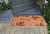 RHS Bloom Coir Collection Maple Leaves doormat in front of a grey door