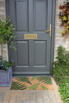 Atlantic Mats RHS Bloom Collection Coir Fern Doormat in front of a grey door