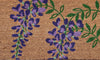 Close-up of a coir doormat featuring purple wisteria flowers and green leaves by Atlantic Mats.