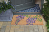 Atlantic Mats RHS Bloom Collection coir doormat with purple wisteria design on a paved porch