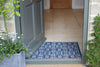 Blue and grey patterned Atlantic Mats RHS Bloom Collection Ocean mat at a doorway
