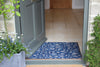 Atlantic Mats RHS Bloom Collection Ocean blue Jekyll Floral doormat at a grey front door entrance