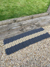 Extra large Atlantic Mats rope doormat in navy and beige on a gravel path