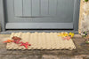 Natural coloured Atlantic Mats outdoor rope doormat with autumn leaves in front of a grey door