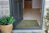Plain green Atlantic Mats ocean mat placed at the entrance of a modern home doorway.