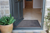 Plain Grey Ocean Mat by Atlantic Mats at an open front door entryway