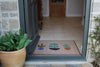 Atlantic Mats Plant Pots Ocean Mat placed at a home entrance doorway